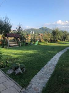 a park with a gazebo in the grass at Casa Cu Lavandă in Valea Drăganului