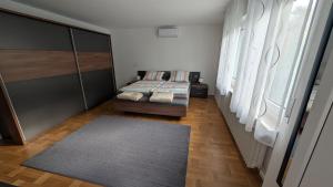 a bedroom with two beds and a rug at Ferienhaus Kusel Blick in Kusel