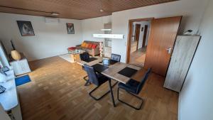 a dining room and living room with a table and chairs at Ferienhaus Kusel Blick in Kusel