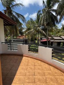 a balcony of a house with palm trees at Perera Tree Villa in Ja-Ela +5 photos