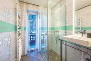 a bathroom with a sink and a shower at Blackriver Lodge Saalbach in Saalbach-Hinterglemm
