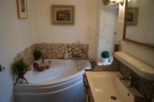 a bathroom with a large tub and a sink at Chambre des amoureux, la Casamatta in Centuri