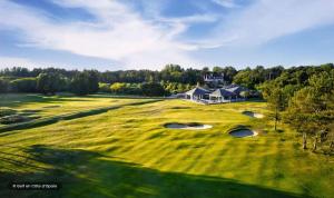 an aerial view of a golf course with a house at Bambou Zen Room in Rang-du-Fliers