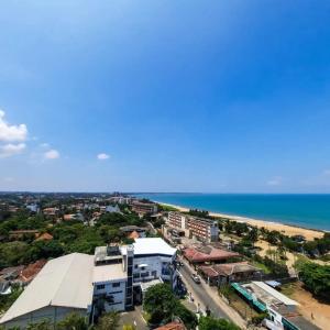 an aerial view of a city and the ocean at Negombo Sea waves in Negombo