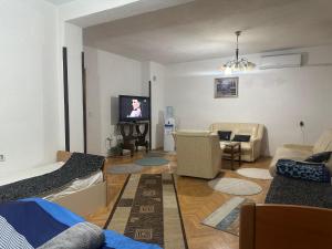 a living room with a couch and a tv at Hostel Struga in Struga