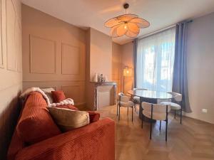a living room with a couch and a table at Maisons Sauvages - Piscine & Jacuzzi - Proche Zoo de Beauval & Châteaux in Romorantin +127 photos