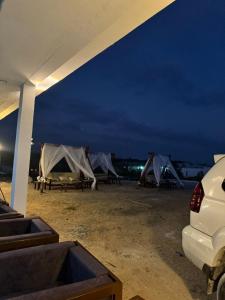 a group of tents in a field at night at Maan Resort in Mogadishu