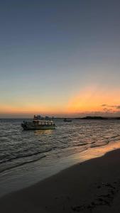 a boat floating in the water at sunset at Maan Resort in Mogadishu