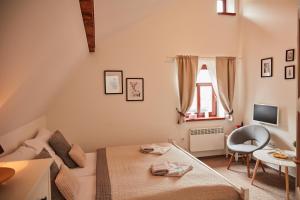 a small living room with a couch and a table at Penzion Štěrbova vila in Bílá Třemešná