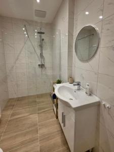 a white bathroom with a sink and a mirror at Ferienwohnung "Wohnung in Haus" in Neunkirchen +23 photos