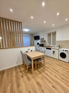 a large kitchen with a wooden table and chairs at Ferienwohnung "Wohnung in Haus" in Neunkirchen