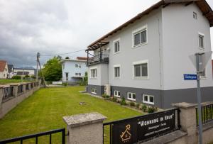 a white building with a sign on the side of it at Ferienwohnung "Wohnung in Haus" in Neunkirchen