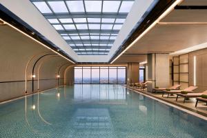 a pool in a building with a view at Sheraton Vinh in Yên Thinh (1)