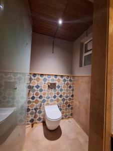 a bathroom with a toilet and a sink and a tub at Kayo Resort Pench in Seonī +8 photos