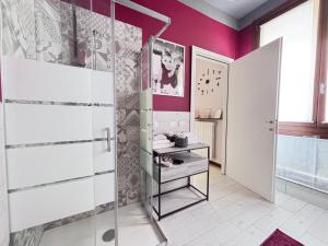 a bathroom with a glass shower and purple walls at Casa di Silvia city center in Verona +26 photos