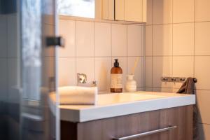 a kitchen with a sink and a bottle of wine at Villa valen, Reine in Moskenes +9 photos