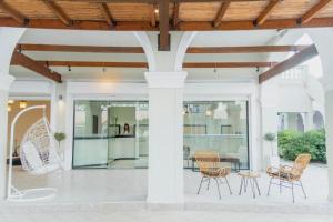 a patio with chairs and a table in a building at Ionian Blue Beach Hotel - Adults Only in Kavos +44 photos