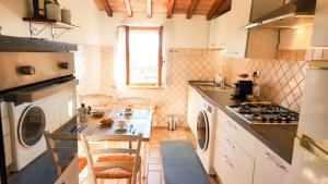 a kitchen with a sink and a stove top oven at Cozy 18th century house in San Gimignano