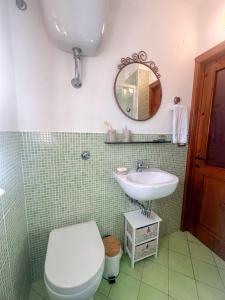 a bathroom with a toilet and a sink at Cozy 18th century house in San Gimignano