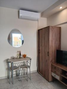 a dining room with a table and a cabinet at Ioana Sea View in Corfu