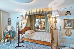 a bedroom with a canopy bed and a mirror at Historic Cinema Suite with Private Art Collection - Basel in Basel