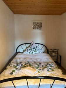 a bedroom with a bed with a bedspread on it at Ferienhaus Eifelperle in Blankenheim