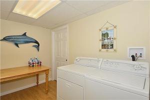 a laundry room with a shark on the wall at Relaxing Beginnings in Cape May Point