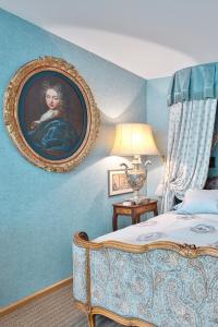 a bedroom with a painting of a woman on the wall at Historic Cinema Suite with Private Art Collection - Basel in Basel
