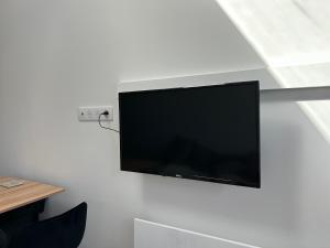 a flat screen tv hanging on a wall at Solar Dream - close to Disney in Lagny