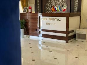 a lobby with a hotel sign on a tile floor at Amir Mumtoz Boutique hotel in Bukhara
