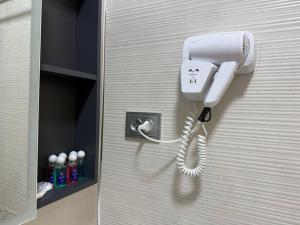 a white phone is hanging on a wall at Amir Mumtoz Boutique hotel in Bukhara