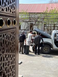 a group of people standing next to a truck at Amir Mumtoz Boutique hotel in Bukhara