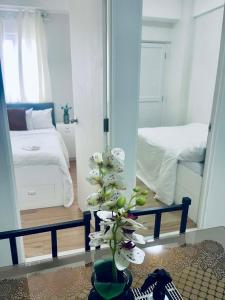 a room with a mirror and a plant on a table at NagaCityRiverView 2BR Apartment in Naga +29 photos