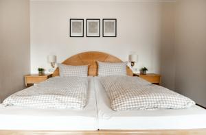 a bedroom with two beds and two night stands at Ferienwohnungen Steinbacher in Vogtareuth