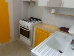 a kitchen with a stove and a sink at Tunisian style in La Marsa