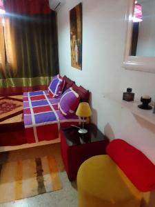 a bedroom with a bed and a table and a chair at Tunisian style in La Marsa