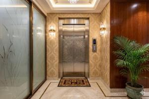 a hallway with a elevator in a building at Hotel Sweet Place in Dhaka