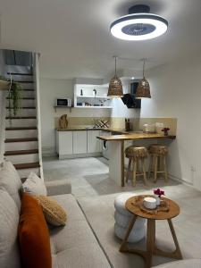 a kitchen and living room with a couch and a table at Charmant Appartement Grand Gosier in Le Gosier