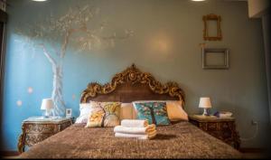 a bedroom with a bed with a tree painted on the wall at Alojamientos Sueños de Ronda in Ronda +30 photos