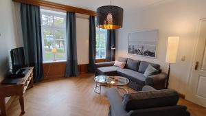 a living room with a couch and a table at Ferienwohnung Fehmarn in Fehmarn