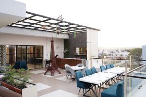 a patio with tables and chairs on a balcony at Hotel Leena Inn in Jhālāwār