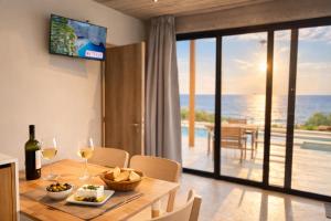 a dining room with a table and a view of the ocean at Sea view villa with private swimming pool in Heraklio
