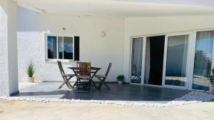 a patio with a table and chairs on it at Casa da praia in Aljezur