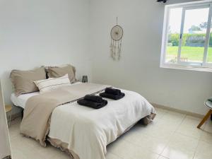 a bedroom with a bed with two towels on it at Casa da praia in Aljezur