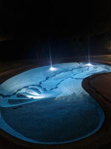 a pool of snow at night with lights at Casa Lori in Fauglia +4 photos