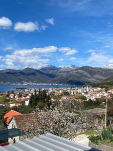 a view of a city with snow capped mountains at Bela Rada in Tivat