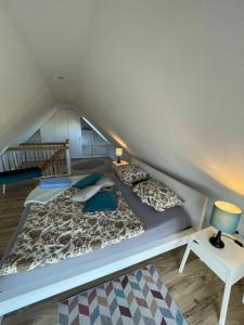 a large bed with pillows and a lamp in a room at Ferienwohnungen in Wremen in Wremen