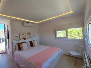 a white bedroom with a bed and a window at El Torreón del Palacio in Boadilla del Monte +30 photos