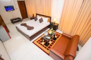 an overhead view of a bedroom with a bed and a couch at Hotel Sweet Place in Dhaka