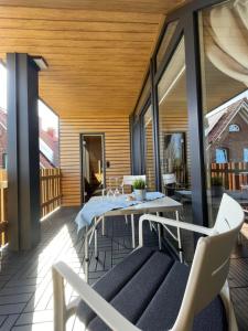 a patio with a table and chairs on a balcony at Ferienwohnungen in Wremen in Wremen